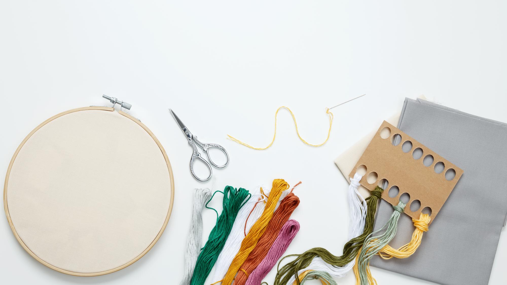 Studio workspace with hoops and threads