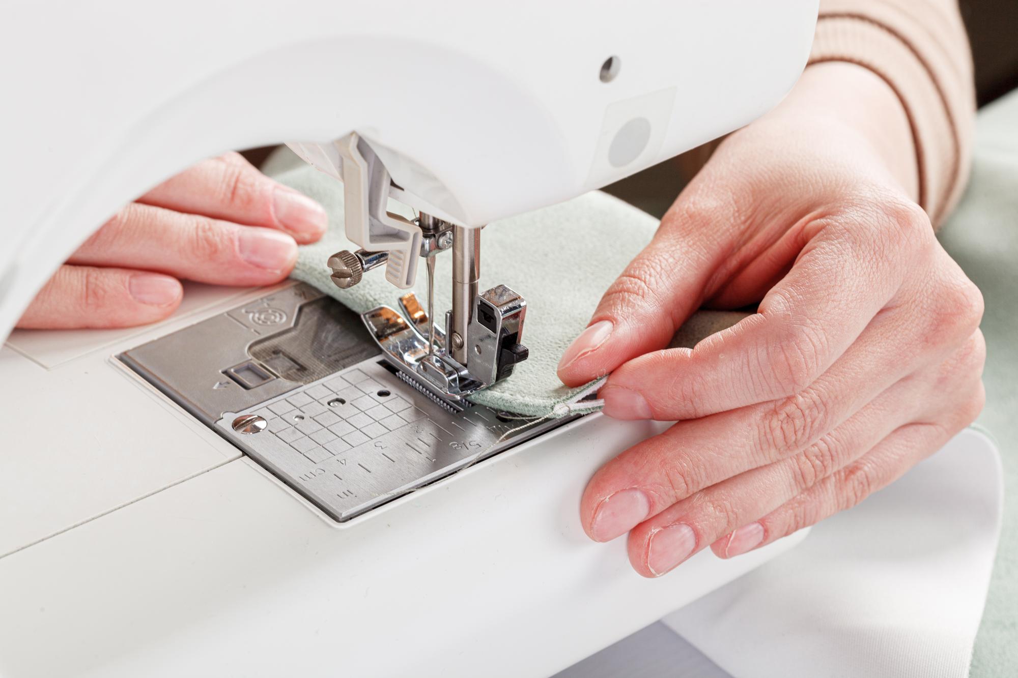 Hands at an embroidery machine in studio